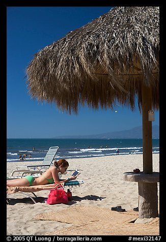 Woman in swimsuit reading on beach chair, Nuevo Vallarta, Nayarit. Jalisco, Mexico (color)