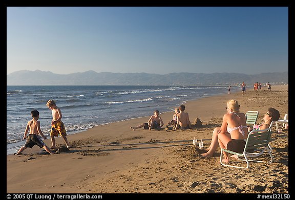 Mothers sitting on beach chairs watching children play in sand, Nuevo Vallarta, Nayarit. Jalisco, Mexico (color)