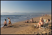 Mothers sitting on beach chairs watching children play in sand, Nuevo Vallarta, Nayarit. Jalisco, Mexico