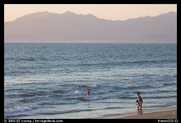 Woman holding children on the beach at sunset, Nuevo Vallarta, Nayarit. Jalisco, Mexico (color)