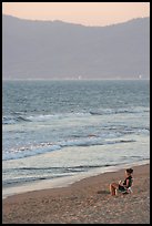 Woman sitting on the beach looking at the sunset, Nuevo Vallarta, Nayarit. Jalisco, Mexico ( color)