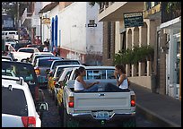 Young women riding in the back of a pick-up truck in a busy street, Puerto Vallarta, Jalisco. Jalisco, Mexico (color)