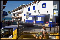 Girl riding in the back of pick-up truck in a street close to ocean, Puerto Vallarta, Jalisco. Jalisco, Mexico (color)