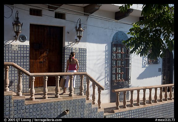 Woman waiting at the door of a house, Puerto Vallarta, Jalisco. Jalisco, Mexico (color)