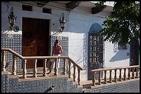 Woman waiting at the door of a house, Puerto Vallarta, Jalisco. Jalisco, Mexico (color)