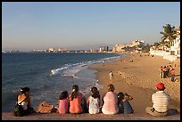 Family sitting above the beach, late afternoon, Puerto Vallarta, Jalisco. Jalisco, Mexico (color)