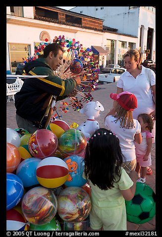 Children, mother, and balloon vendor , Puerto Vallarta, Jalisco. Jalisco, Mexico