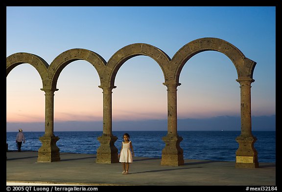 Girl standing by the Malecon arches at sunset, Puerto Vallarta, Jalisco. Jalisco, Mexico (color)