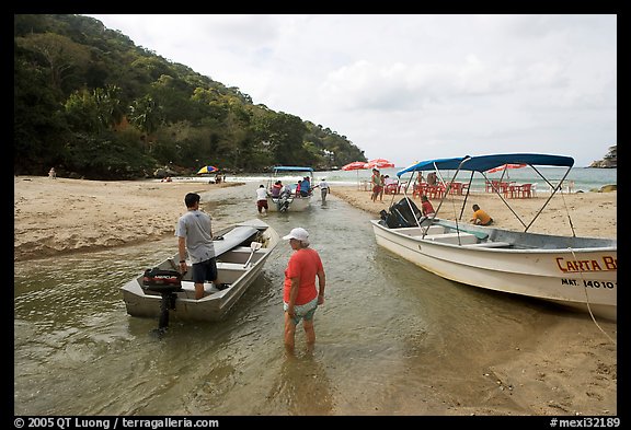 Boats moving from lagoon to ocean via small channel,  Boca de Tomatlan, Jalisco. Jalisco, Mexico (color)