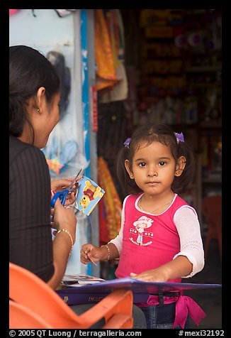 Girl playing with collages,  Boca de Tomatlan, Jalisco. Jalisco, Mexico