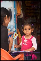 Girl playing with collages,  Boca de Tomatlan, Jalisco. Jalisco, Mexico ( color)