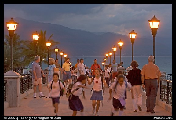 Children running on footbridge above Rio Cuale at dusk, Puerto Vallarta, Jalisco. Jalisco, Mexico