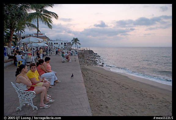 Women sitting on a bench looking at the ocean, Puerto Vallarta, Jalisco. Jalisco, Mexico (color)