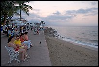 Women sitting on a bench looking at the ocean, Puerto Vallarta, Jalisco. Jalisco, Mexico