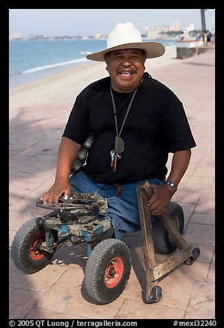 Man without legs  smiling on the Malecon, Puerto Vallarta, Jalisco. Jalisco, Mexico (color)