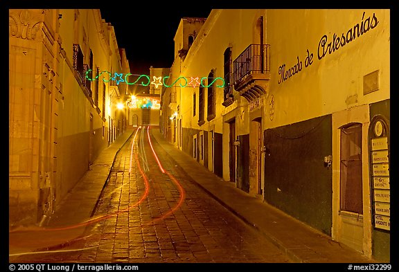 Uphill paved street by night with light trail. Zacatecas, Mexico