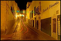 Uphill paved street by night with light trail. Zacatecas, Mexico