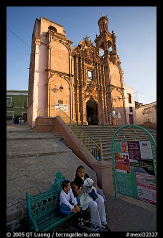 Woman and child waiting for bus below a church. Guanajuato, Mexico