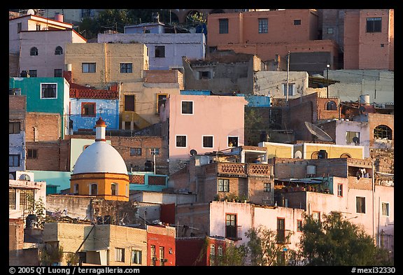 Multicolored houses on a steep hillside, late afternoon. Guanajuato, Mexico