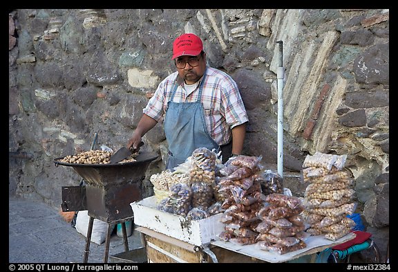 Man selling grilled peanuts on the street. Guanajuato, Mexico