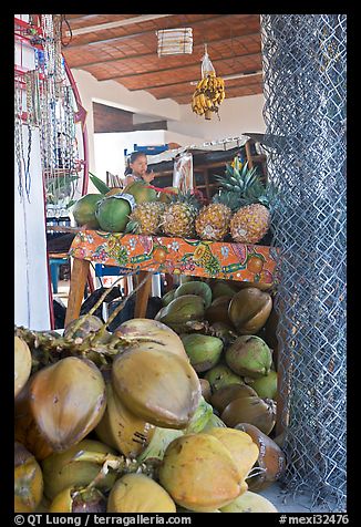 Tropical Fruit stand with girl in background. Mexico