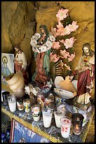 Religious figures and candles in roadside chapel. Mexico (color)