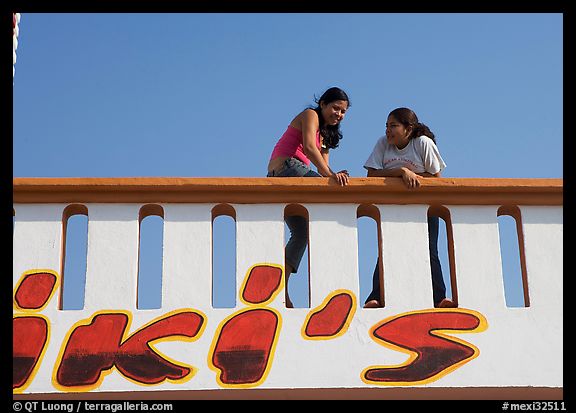 Young women sitting on a roof. Mexico