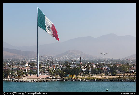 Giean Mexican national flag flying above Malecon, Ensenada. Baja California, Mexico