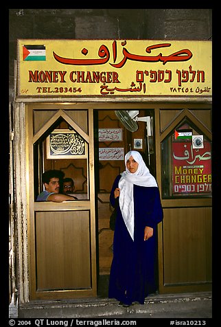 Muslem woman exiting a money changing booth. Jerusalem, Israel (color)