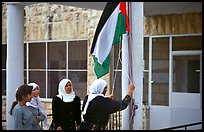 Women raise the Palestian flag at a school in East Jerusalem. Jerusalem, Israel ( color)