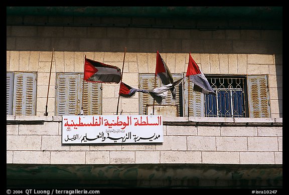 Palestinian flags and inscriptions in arabic in front of a school, East Jerusalem. Jerusalem, Israel (color)