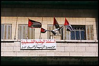 Palestinian flags and inscriptions in arabic in front of a school, East Jerusalem. Jerusalem, Israel (color)