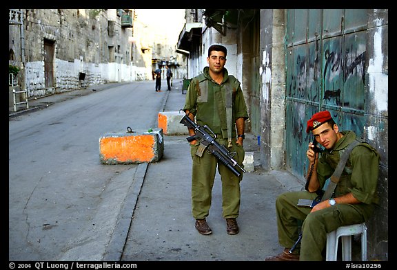 Two young israeli soldiers manning a checkpoint, Hebron. West Bank, Occupied Territories (Israel)