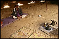 Bedouin man sitting on a carpet in a tent, Judean Desert. West Bank, Occupied Territories (Israel)