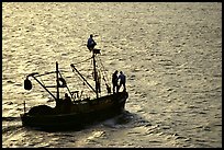 Small fishing boat silhouetted, late afternoon, Akko (Acre). Israel (color)