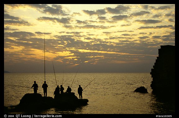 Fishermen standing on a rock, Akko (Acre). Israel (color)