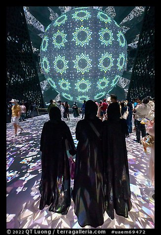 Women in abaya at light show, Saudi Arabia Pavilion. Expo 2020, Dubai, United Arab Emirates (color)