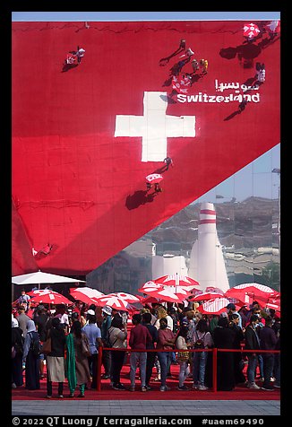 Visitors with umbrellas, Swizerland Pavilion. Expo 2020, Dubai, United Arab Emirates