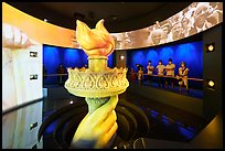Visitors look at replica of Statue of Liberty torch, USA Pavilion. Expo 2020, Dubai, United Arab Emirates ( color)
