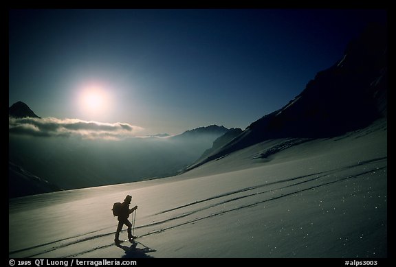 Backcountry skier climbs Dome de Chasseforet in the Vanoise Range, Alps, France.  (color)