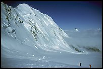 Backcountry skiers dwarfed by Liskam, Switzerland. (color)