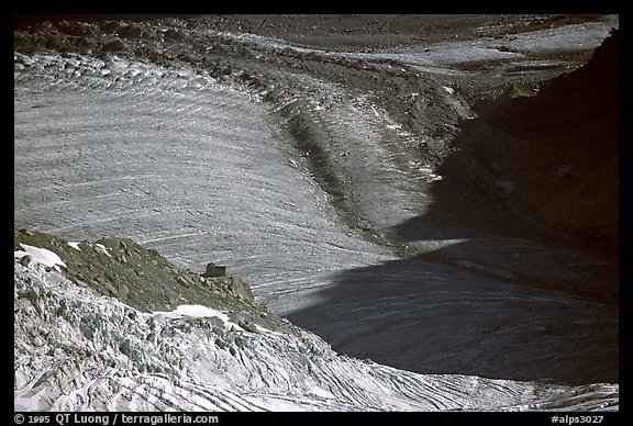 Forbes bands on Mer de Glace. Their shape indicate the differential in flow speed; the Requin hut gives the scale. Alps, France