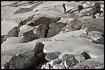 Party crosses a snow bridge in the upper Vallee Blanche in summer, Mont-Blanc range, Alps, France.