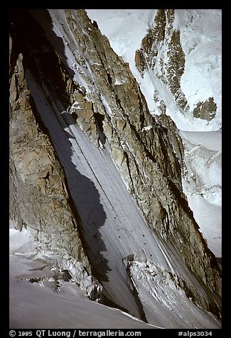 Two parties climbing on the lower half of the North face of Tour Ronde, Mont-Blanc range, Alps, France.