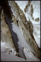 Two parties climbing on the lower half of the North face of Tour Ronde, Mont-Blanc range, Alps, France.