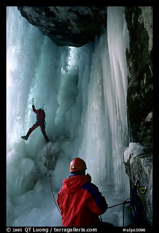 Paul and Vincent are going to avoid the vertical free standing section of the main falls of Gialorgues by climbing through an ice-tunnel, an experience of rare beauty. Alps, France (color)