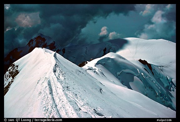 Summit ridge of Mont-Blanc and Bosses ridge with climber's trail in the snow, France and Italy.