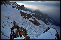 Climbers on the rocky part of the Brenva Spur, Mont-Blanc, Italy.