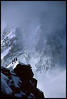 Alpinists on a buttress of Aiguille du Midi climbing the Cosmiques ridge. Alps, France