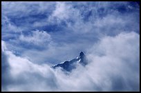 Aiguille du Midi summit emerges from the clouds. Alps, France (color)